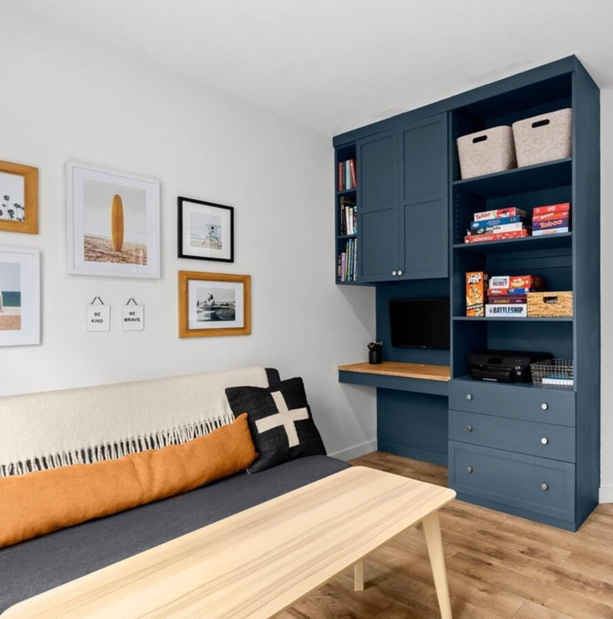 Kids playroom with builtin desk area and storage.